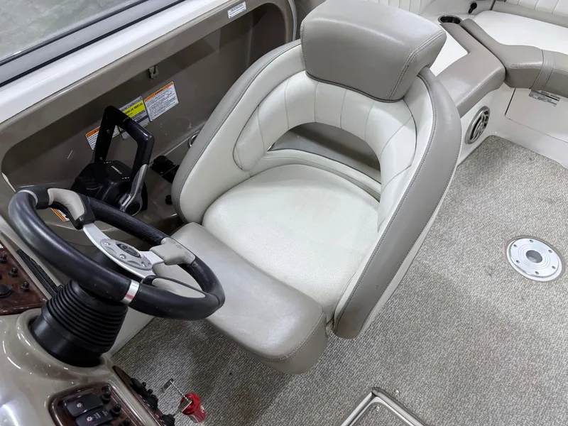 Slide: The Image of 2009 Yamaha Boats 232 Limited S interior with steering wheel and cushioned seat. - 16