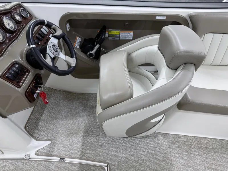Slide: The Image of 2009 Yamaha Boats 232 Limited S interior with steering wheel and captain's chair. - 17