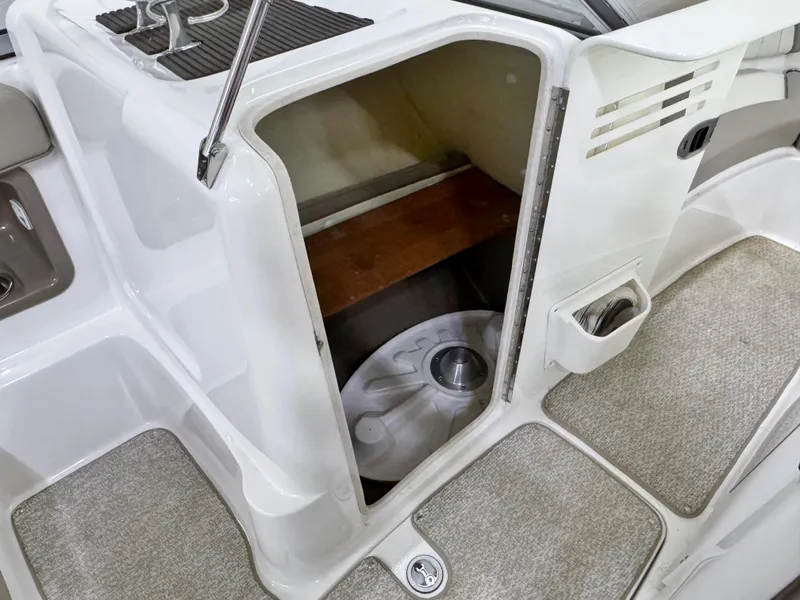 Slide: The Image of Storage compartment on a 2009 Yamaha Boats 232 Limited S, featuring carpeted flooring. - 18