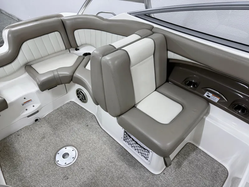 Slide: The Image of 2009 Yamaha Boats 232 Limited S interior with beige and white seating, carpeted floor. - 9