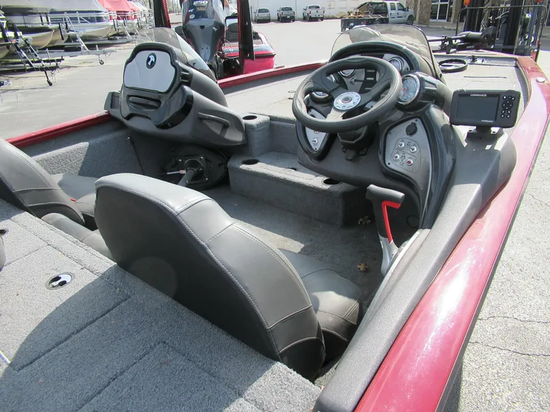 Slide: The Image of 2021 Bass Tracker PT195 TXW boat interior with steering wheel and seating. - 2