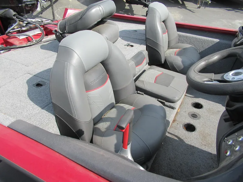 Slide: The Image of 2021 Bass Tracker PT195 TXW boat interior with gray and red seating. - 3