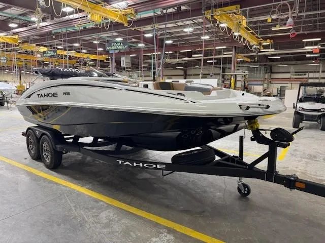 Slide: The Image of 2024 Tahoe 1950 boat on trailer in factory assembly line. - 2