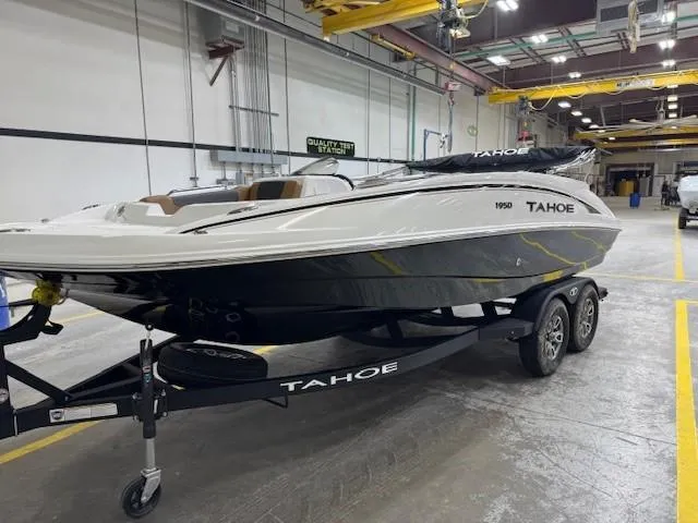 Slide: The Image of 2024 Tahoe 1950 boat on trailer in industrial setting. - 3