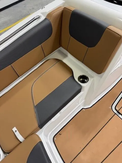 Slide: The Image of 2024 Tahoe 1950 boat interior with tan and black seating, cup holder, and sleek design. - 4
