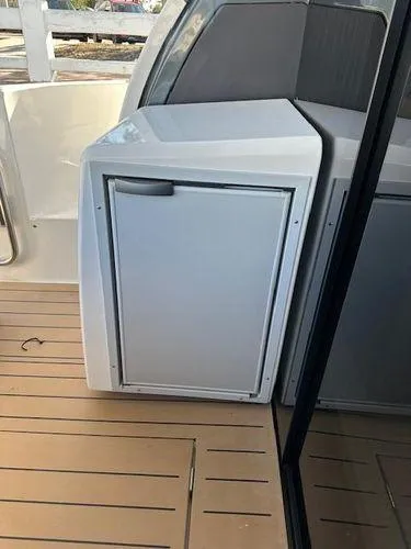Slide: The Image of 2023 Bavaria R40 Coupe yacht interior with sleek cabinetry on wooden deck. - 11
