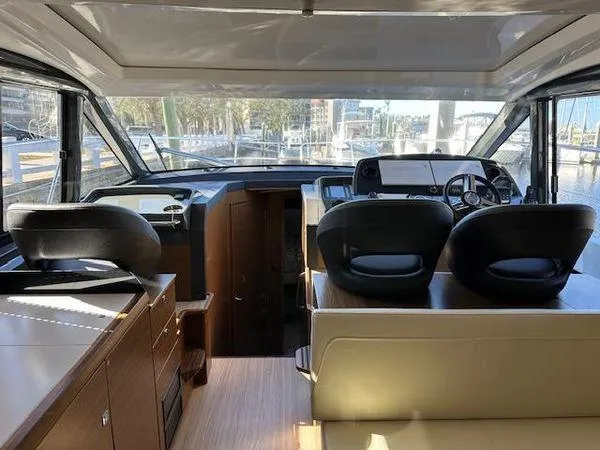 Slide: The Image of Interior of 2023 Bavaria R40 Coupe yacht with modern helm and seating area. - 14