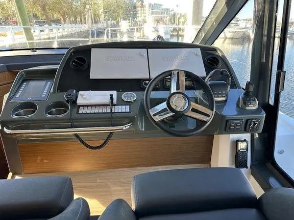Slide: The Image of 2023 Bavaria R40 Coupe helm with modern controls and dual displays. - 19