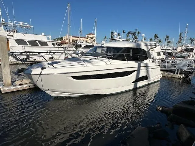 Slide: The Image of 2023 Bavaria R40 Coupe yacht docked in a marina under clear blue skies. - 2