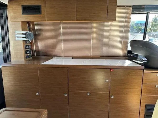 Slide: The Image of Interior of 2023 Bavaria R40 Coupe yacht with modern wooden cabinetry and sleek design. - 29