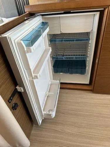 Slide: The Image of Open refrigerator inside 2023 Bavaria R40 Coupe, showcasing spacious interior and shelving. - 32