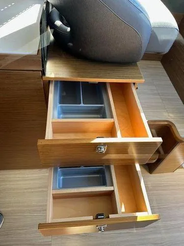 Slide: The Image of 2023 Bavaria R40 Coupe interior with open wooden drawers and storage compartments. - 36