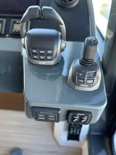 Slide: The Image of 2023 Bavaria R40 Coupe boat controls with joystick and throttle levers. - 41