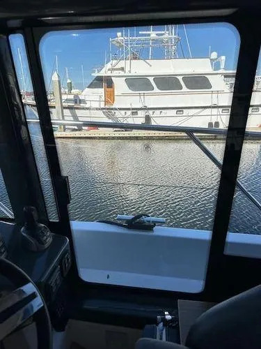 Slide: The Image of View from inside a 2023 Bavaria R40 Coupe, overlooking a marina with docked boats. - 44