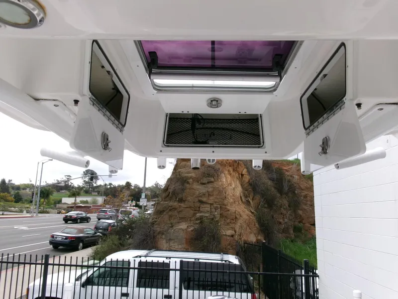 Slide: The Image of 2020 Sea Fox 248 Commander boat interior with storage compartments and overhead lighting. - 22