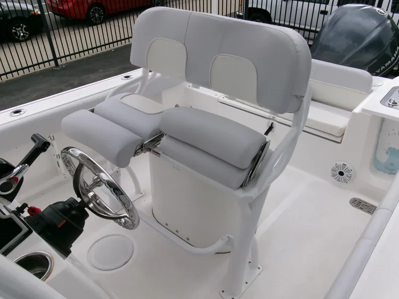 Slide: The Image of 2020 Sea Fox 248 Commander boat helm with cushioned seating and steering wheel. - 23