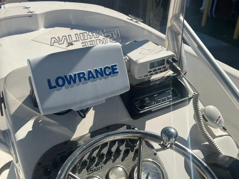 Slide: The Image of 2016 Carolina Skiff 198 DLV boat console with Lowrance navigation system and radio equipment. - 16