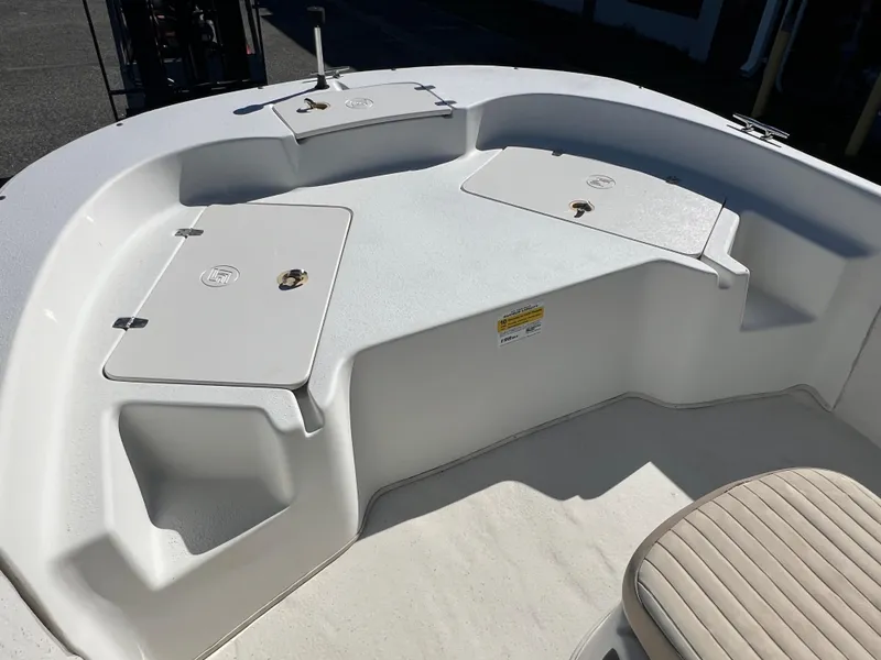 Slide: The Image of 2016 Carolina Skiff 198 DLV boat deck with storage compartments and seating. - 17
