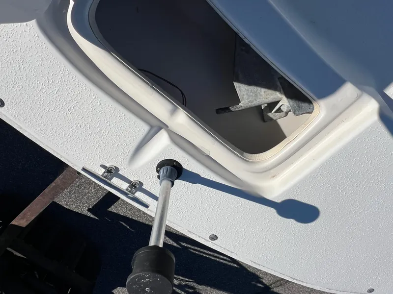 Slide: The Image of 2016 Carolina Skiff 198 DLV boat compartment with open hatch and visible anchor. - 19