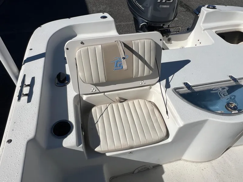 Slide: The Image of 2016 Carolina Skiff 198 DLV boat seating area with cup holders and storage. - 23