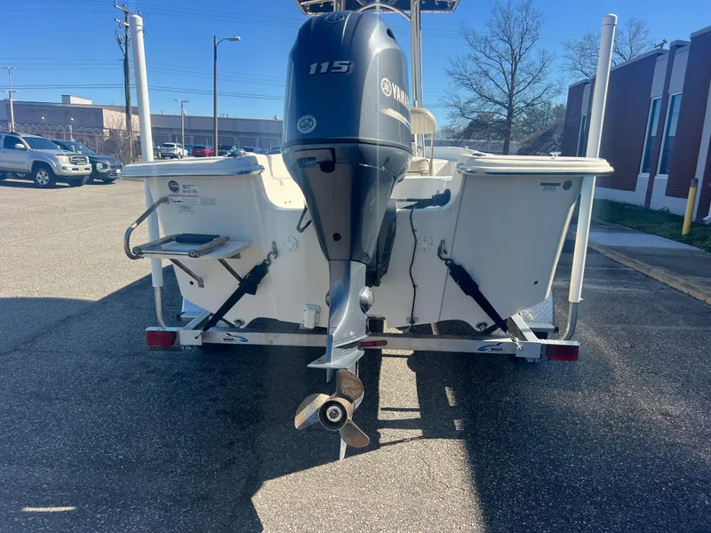 Slide: The Image of 2016 Carolina Skiff 198 DLV boat with Yamaha 115 engine, parked outdoors. - 6