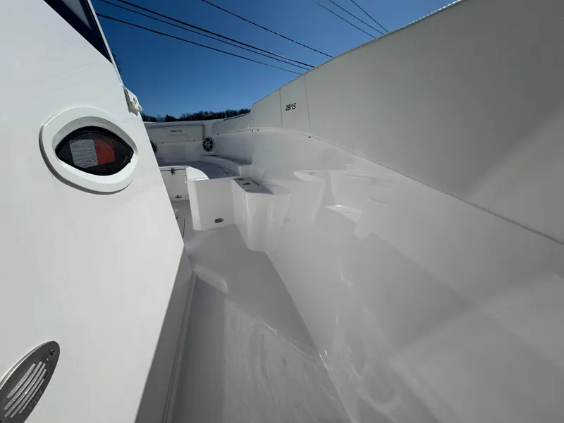 Slide: The Image of 2025 Aquasport 28AS Center Console boat interior, showcasing sleek white design and spacious layout. - 12