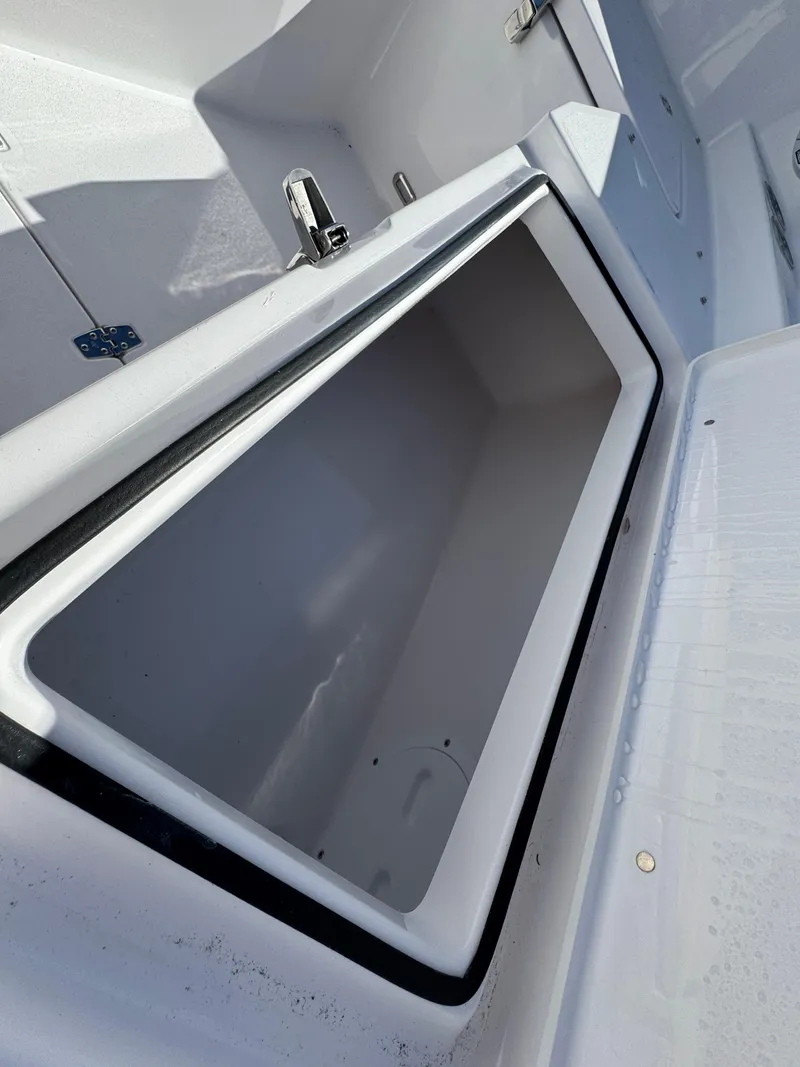 Slide: The Image of 2025 Aquasport 28AS Center Console boat storage compartment, open and empty. - 14