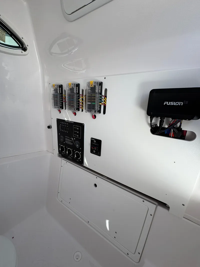Slide: The Image of 2025 Aquasport 28AS Center Console interior with control panel and wiring. - 17