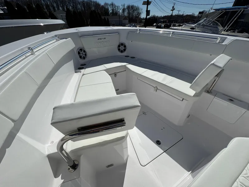 Slide: The Image of 2025 Aquasport 28AS Center Console boat interior with white seating and modern design. - 18