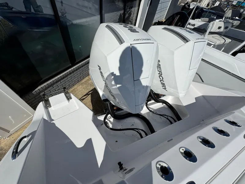 Slide: The Image of 2025 Aquasport 28AS Center Console with dual Mercury outboard engines. - 21