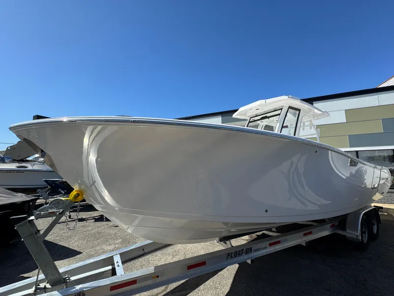 Slide: The Image of 2025 Aquasport 28AS Center Console boat on trailer, displayed outdoors. - 22