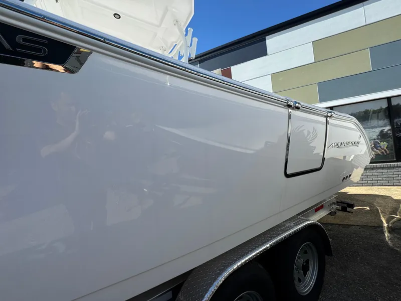 Slide: The Image of 2025 Aquasport 28AS Center Console boat on trailer, side view. - 23
