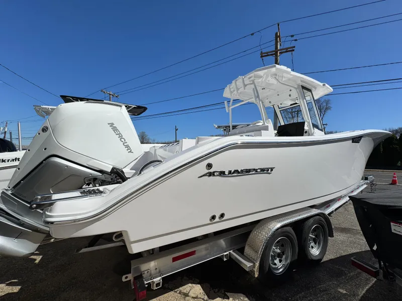 Slide: The Image of 2025 Aquasport 28AS Center Console boat on trailer, side view. - 3