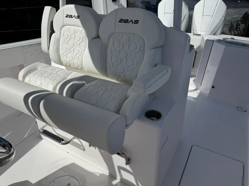 Slide: The Image of 2025 Aquasport 28AS Center Console boat seating with white cushioned seats and armrests. - 6