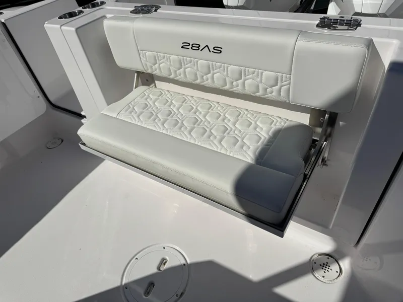 Slide: The Image of 2025 Aquasport 28AS Center Console boat seat with quilted white upholstery. - 8