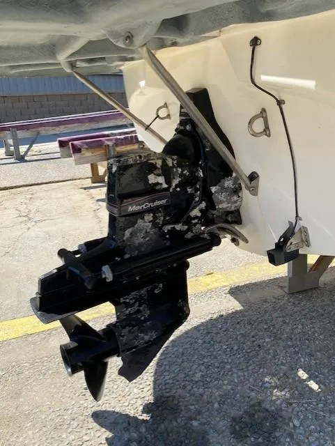 Slide: The Image of 2005 Bayliner 249 SD boat with MerCruiser outdrive, docked on concrete surface. - 10