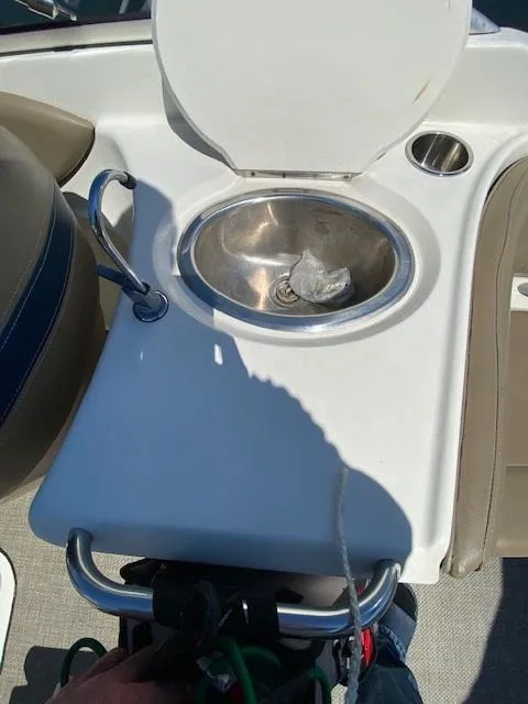 Slide: The Image of 2005 Bayliner 249 SD boat sink with faucet and cup holder on deck. - 13