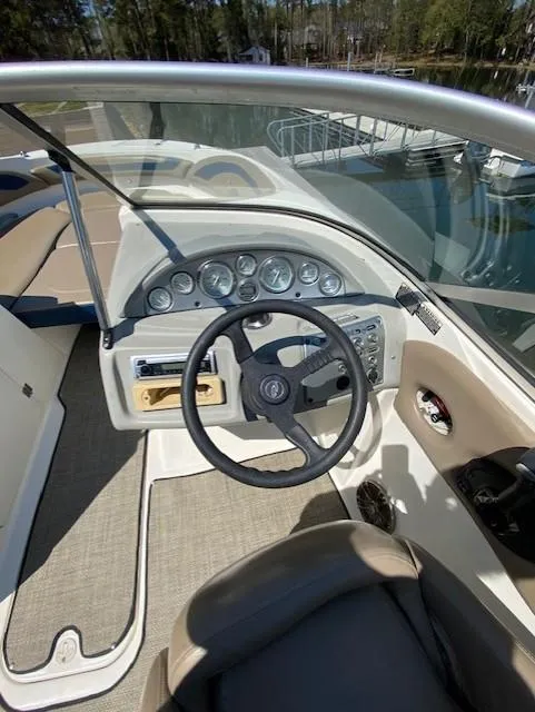 Slide: The Image of 2005 Bayliner 249 SD boat dashboard with steering wheel and instrument panel. - 4