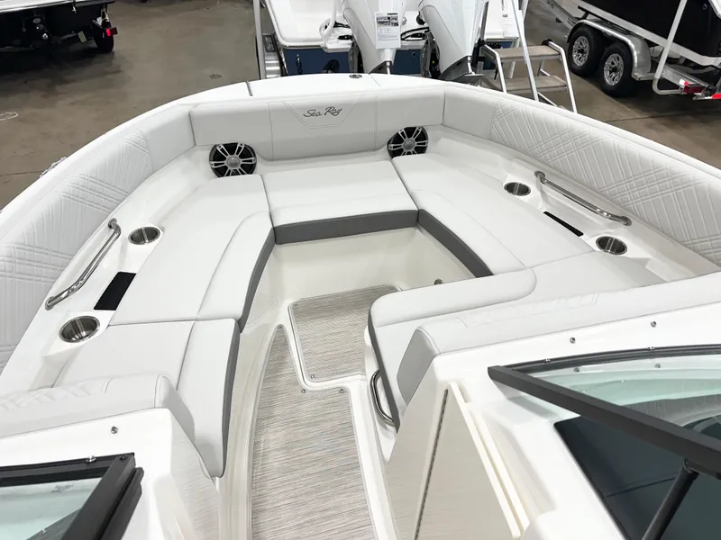 Slide: The Image of 2025 Sea Ray SDX 250 boat interior with white seating and cup holders. - 10