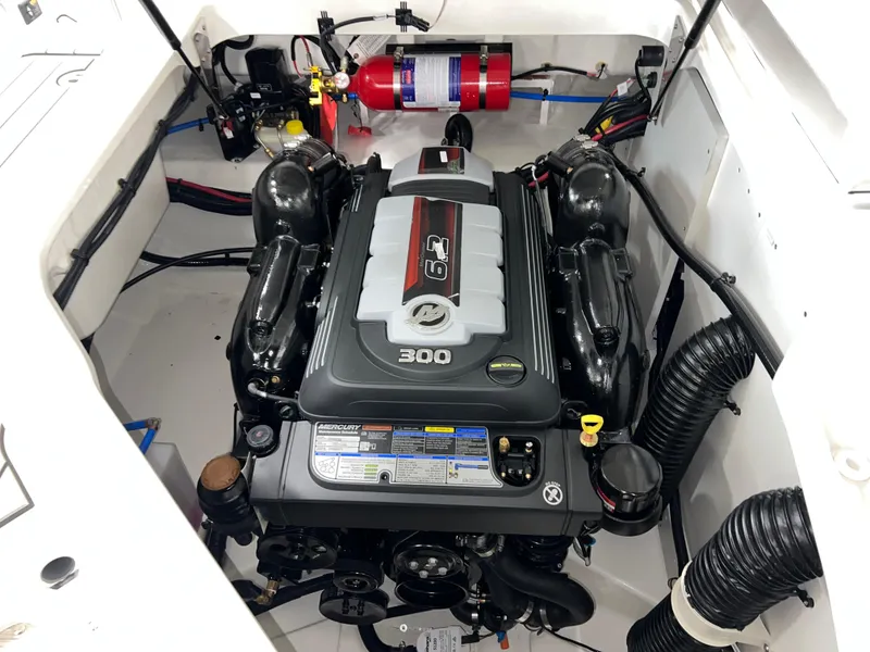 Slide: The Image of 2025 Sea Ray SDX 250 engine compartment with 6.2L 300 HP engine and fire extinguisher. - 12