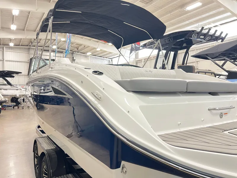 Slide: The Image of 2025 Sea Ray SDX 250 boat with sleek design in indoor showroom. - 4