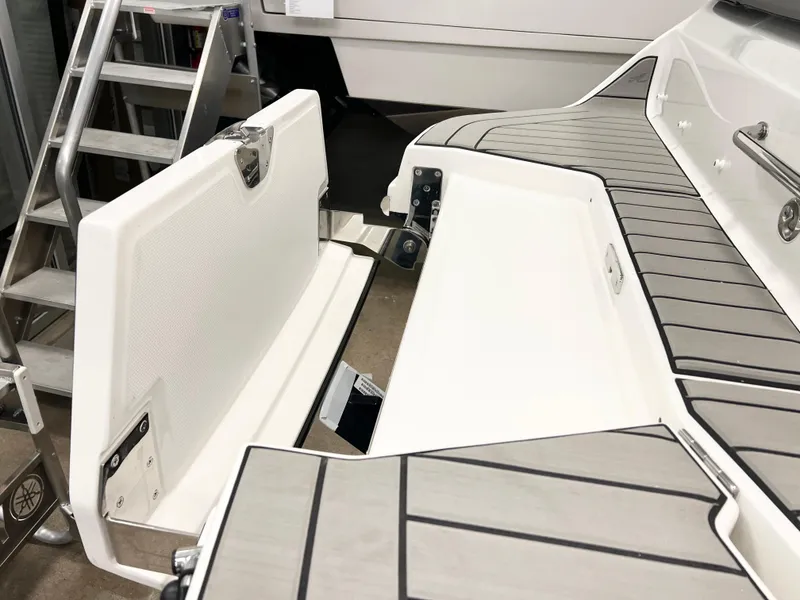 Slide: The Image of 2025 Sea Ray SDX 250 boat interior with open storage compartment and sleek design. - 6
