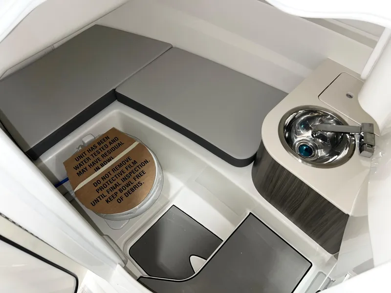 Slide: The Image of 2025 Sea Ray SDX 250 boat interior with seating and compact sink area. - 9