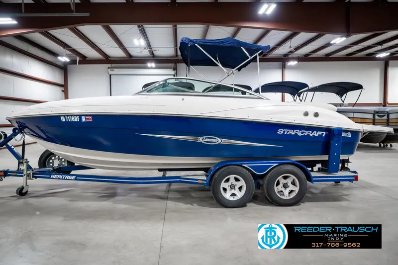 Slide: The Image of 2007 Starcraft Limited 1900 OB boat on trailer in indoor storage facility. - 11