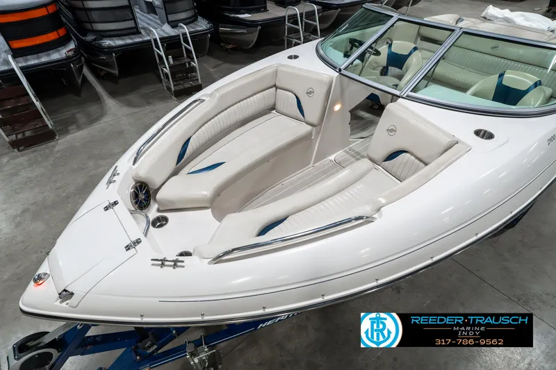 Slide: The Image of 2007 Starcraft Limited 1900 OB boat with beige seating, displayed indoors on a trailer. - 12