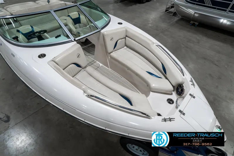 Slide: The Image of 2007 Starcraft Limited 1900 OB boat with white and blue interior, displayed indoors. - 13