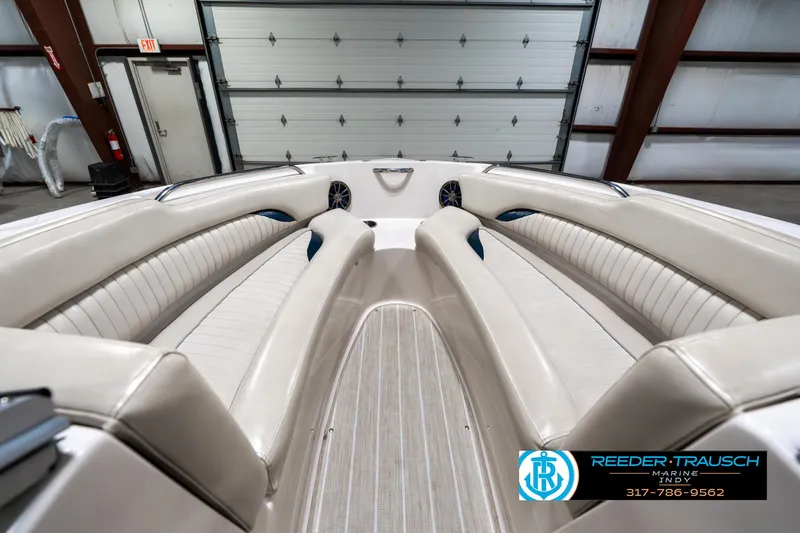 Slide: The Image of 2007 Starcraft Limited 1900 OB boat interior with beige seating in a garage setting. - 18