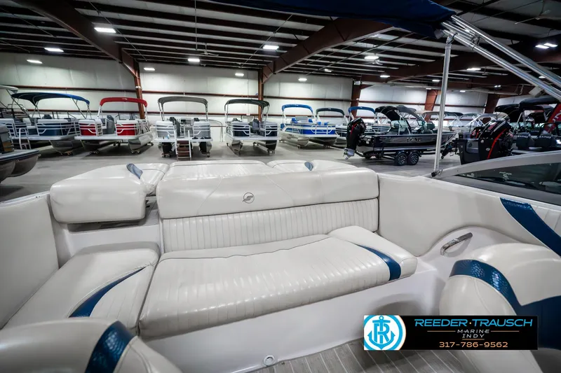 Slide: The Image of 2007 Starcraft Limited 1900 OB boat interior in showroom with multiple boats displayed. - 26