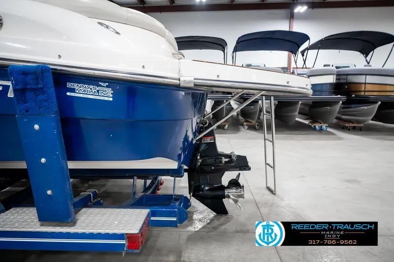 Slide: The Image of 2007 Starcraft Limited 1900 OB boat in showroom, featuring blue hull and outboard motor. - 46