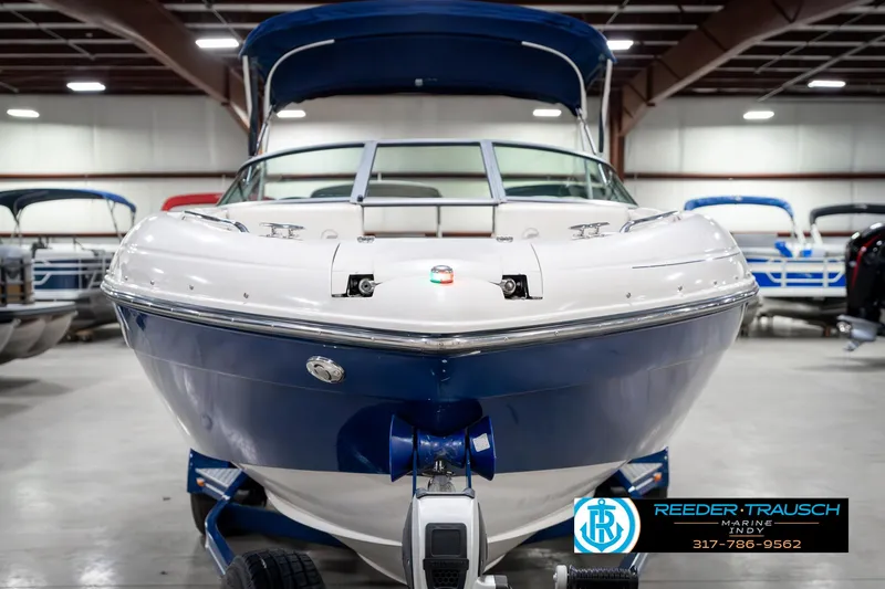 Slide: The Image of 2007 Starcraft Limited 1900 OB boat in showroom, blue and white exterior, front view. - 5
